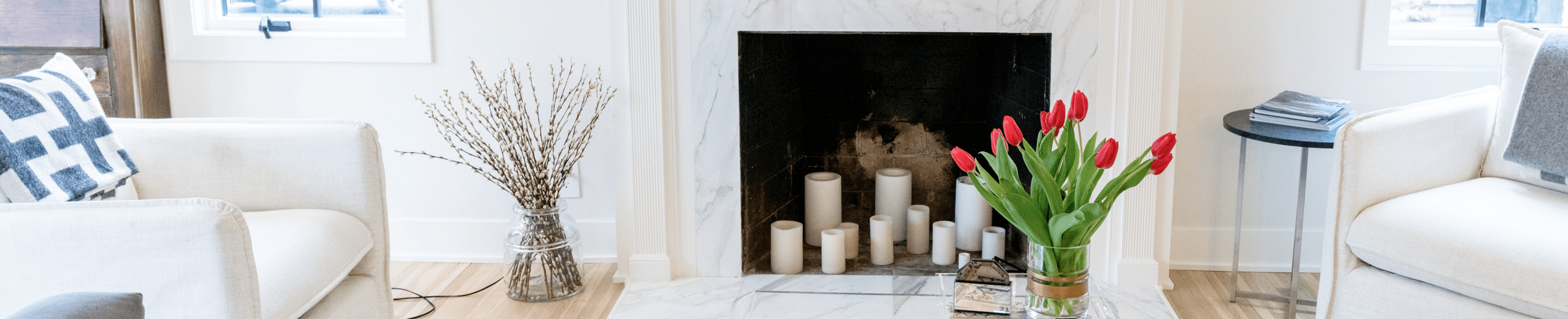 A cozy, uncluttered living room with a lit fireplace