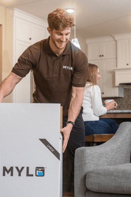 MYLO mover packing a MYLO box in a customer’s kitchen