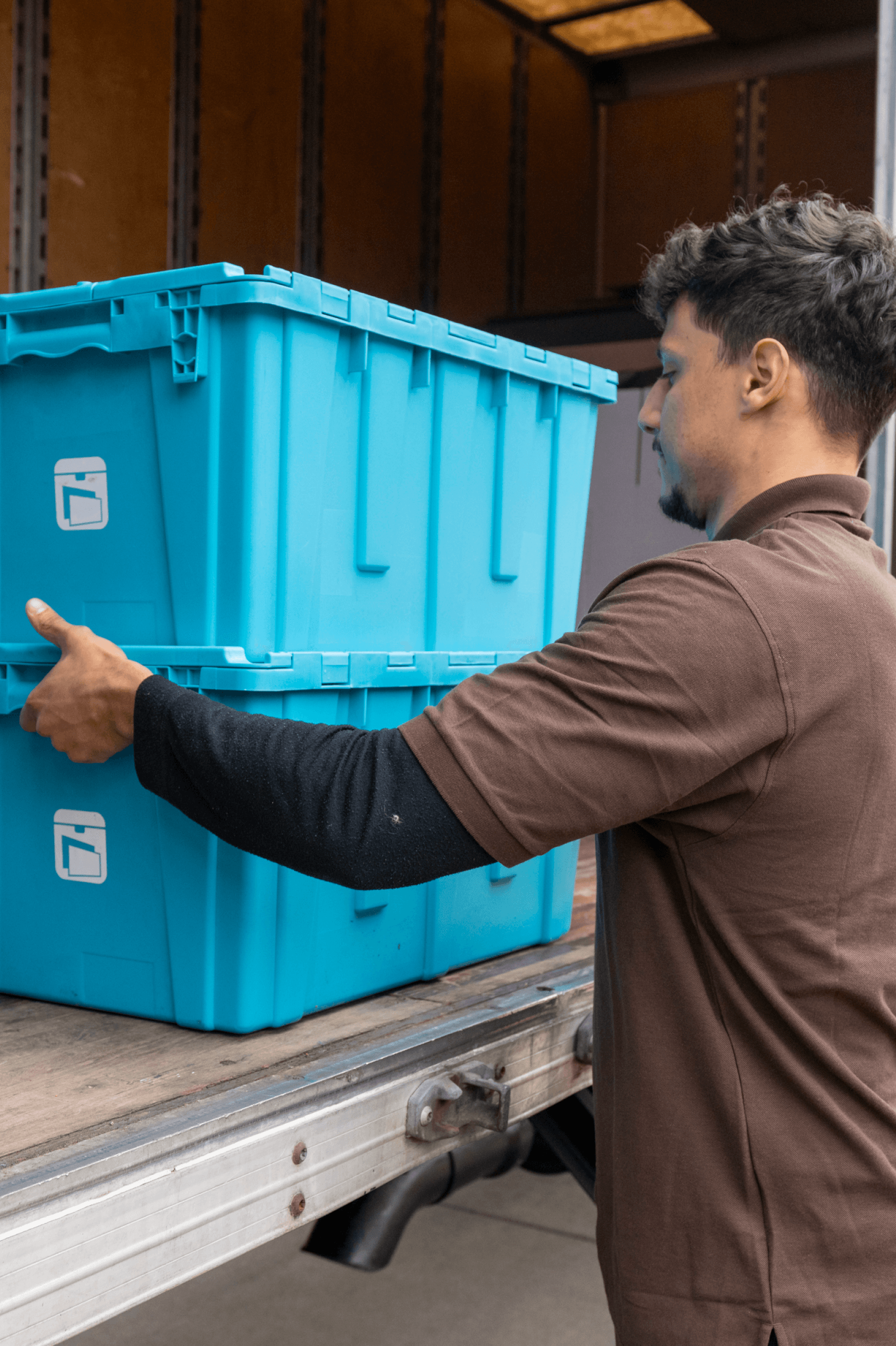 MYLO mover loading blue storage totes into the truck